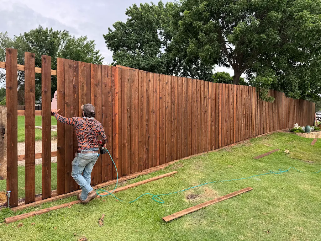 Professional fence installation crew building a cedar privacy fence in Fort Worth